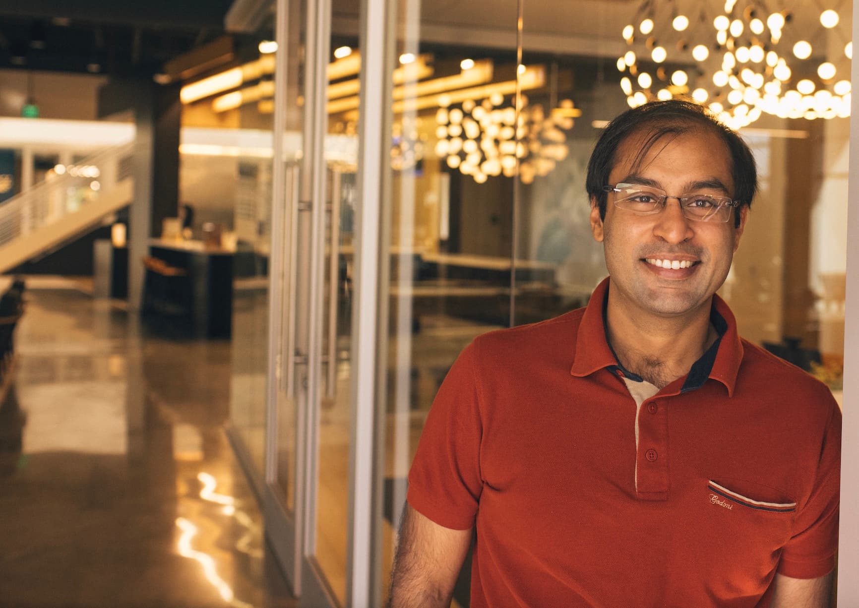 Nimit Jain leaning against a wall at an Altos Labs office